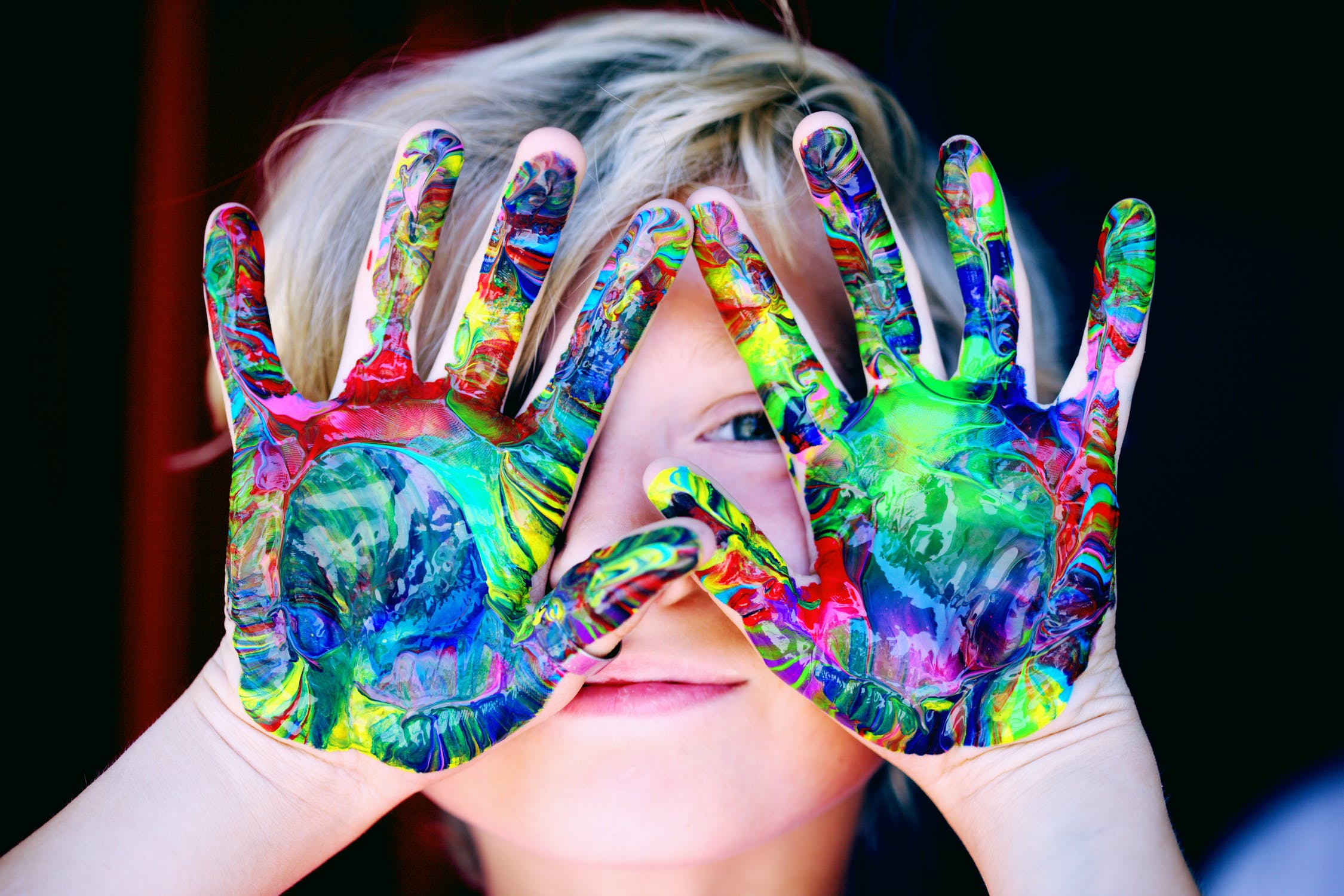 Child with paint all over their hands