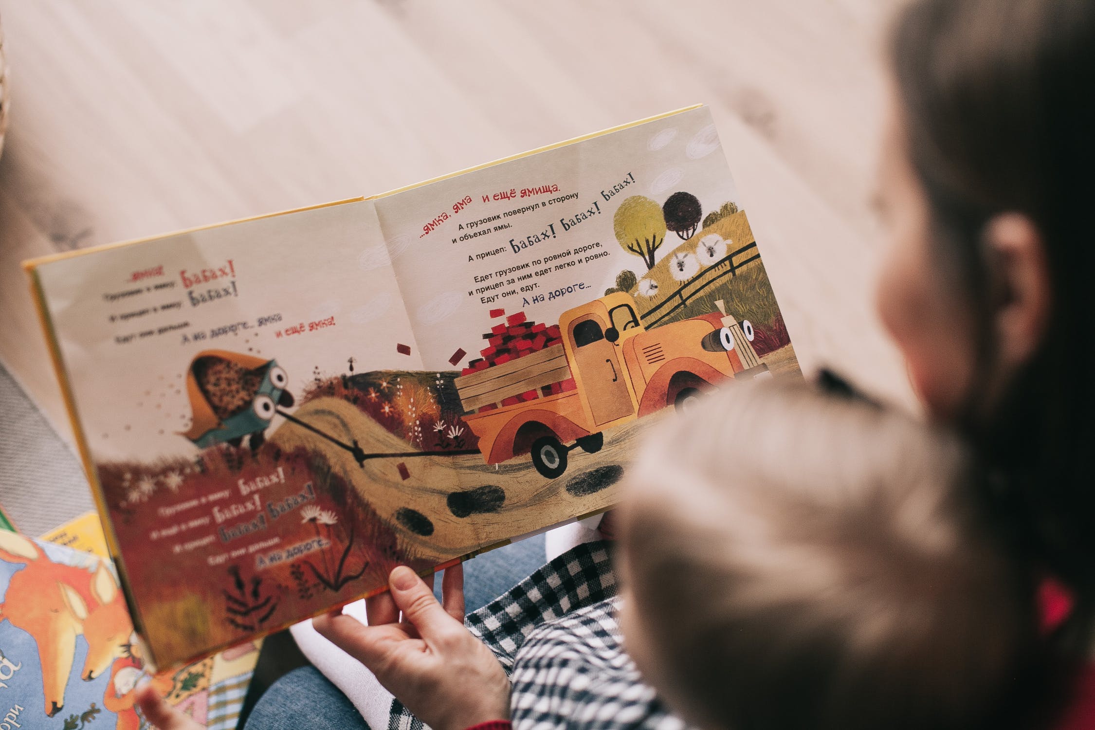 Adult reading a book to a child
