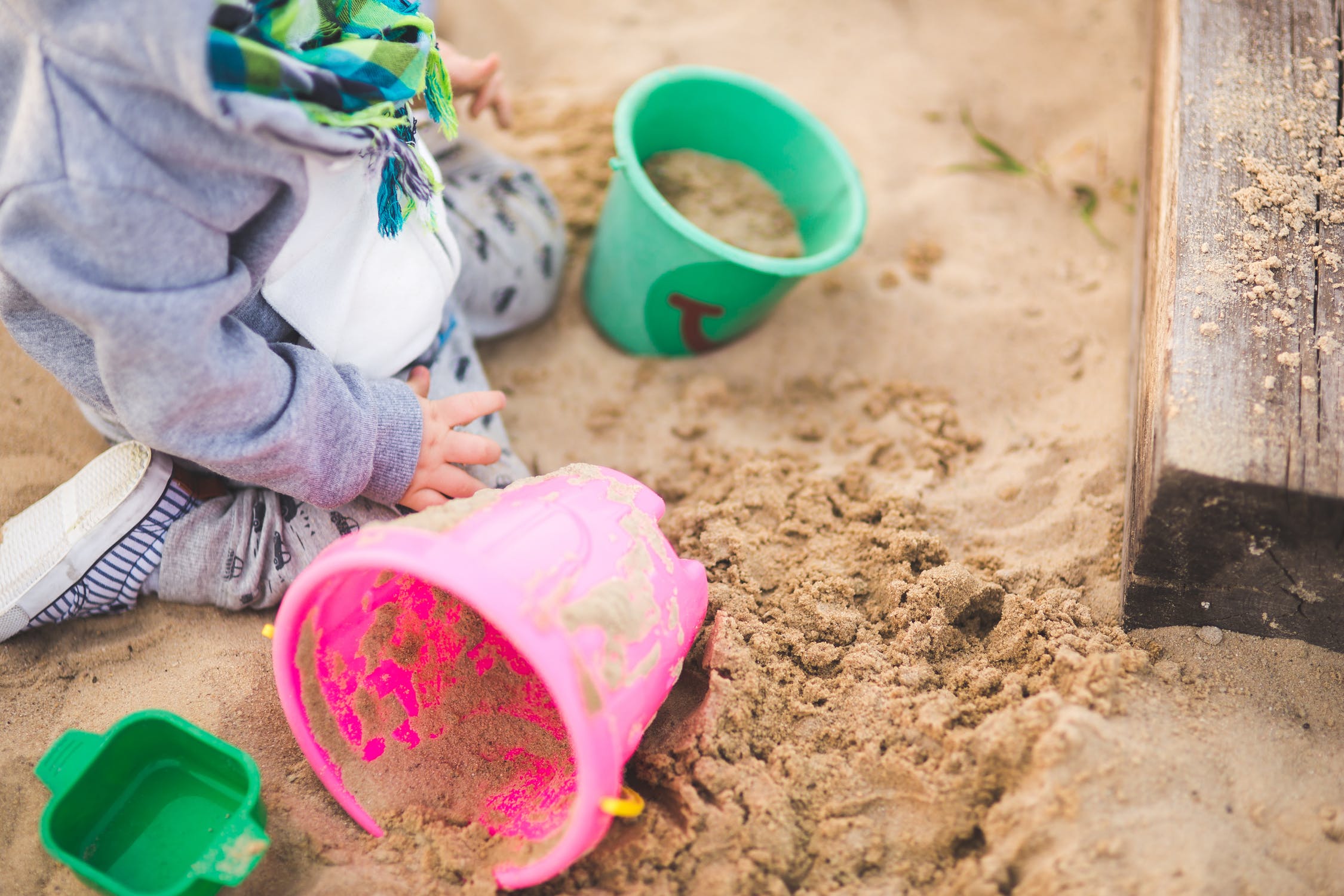 Toddler playing in a sandpit