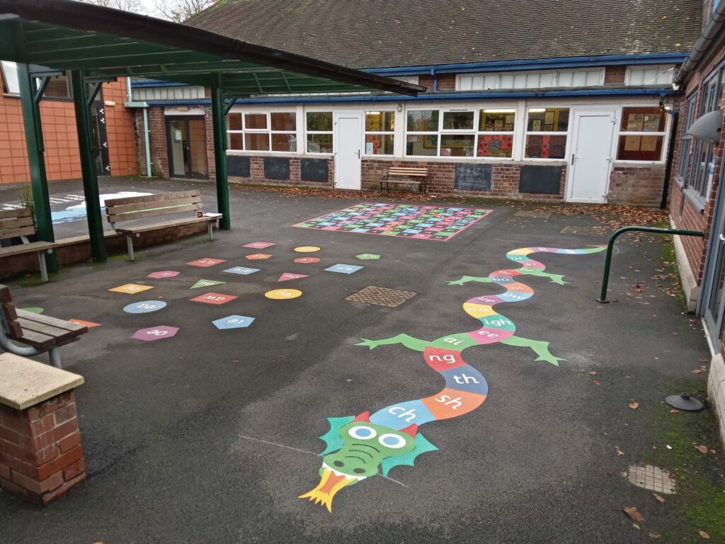 rainbow coloured hopscotch in the shape of a dragon
