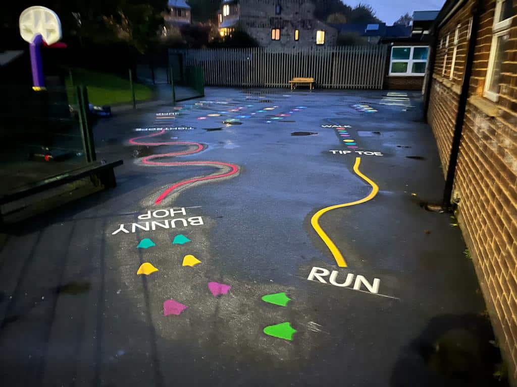 Broadgate Primary trail, night, wet, buildings with lights on in brackground